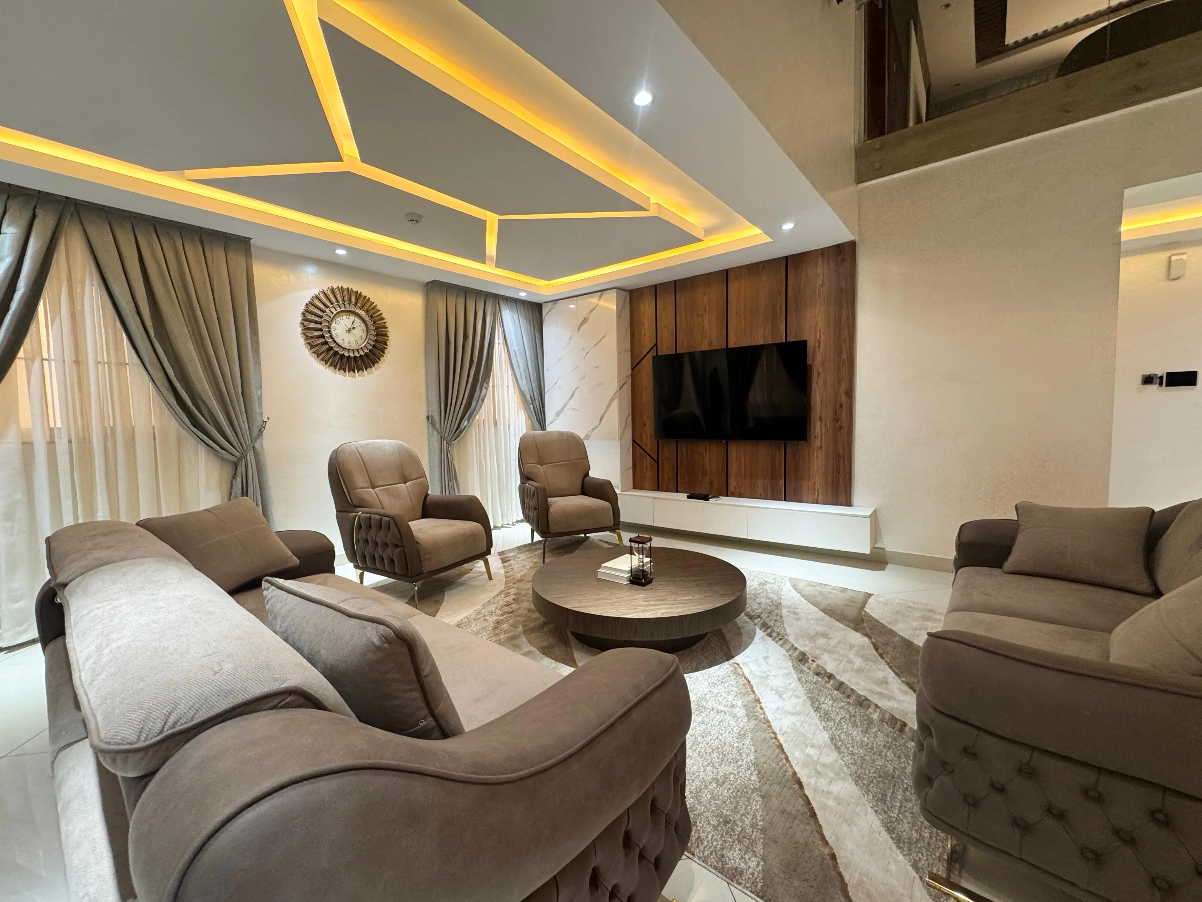 Spacious upper-level living room with chandelier